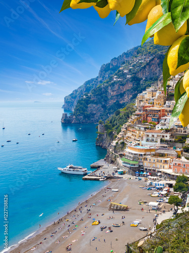 Picturesque Positano on Amalfi Coast, Italy, with colorful houses on cliffs and clear blue waters of Mediterranean sea. Vibrant ripe yellow lemons in foreground. Welcome to Positano!
