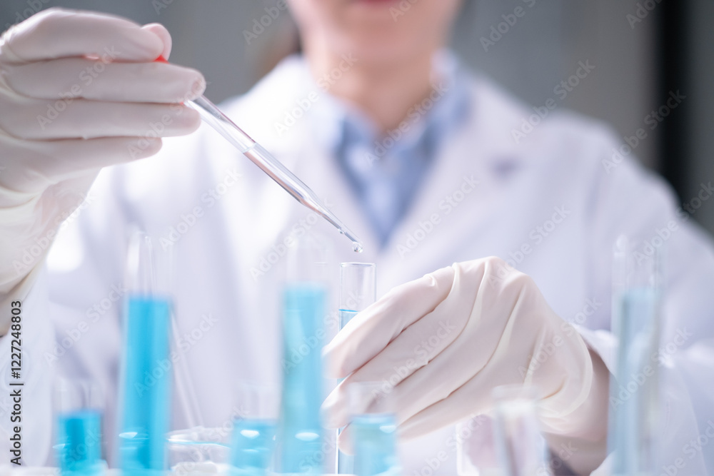 Fototapeta premium Close-up scientist pipette drop to test tube laboratory research chemistry chemical science research
