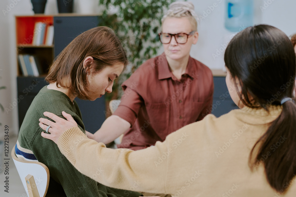 Obraz premium Counselor and two women engaging in supportive therapy session in cozy room with plants and bookshelves calming ambiance enhancing emotional connection