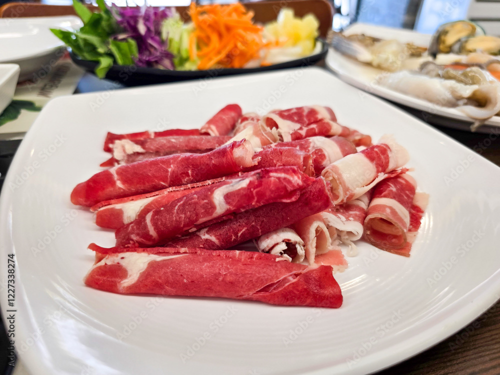 Shabu Shabu. Thinly sliced beef on a plate Shabu Shabu. Thinly sliced beef on a plate