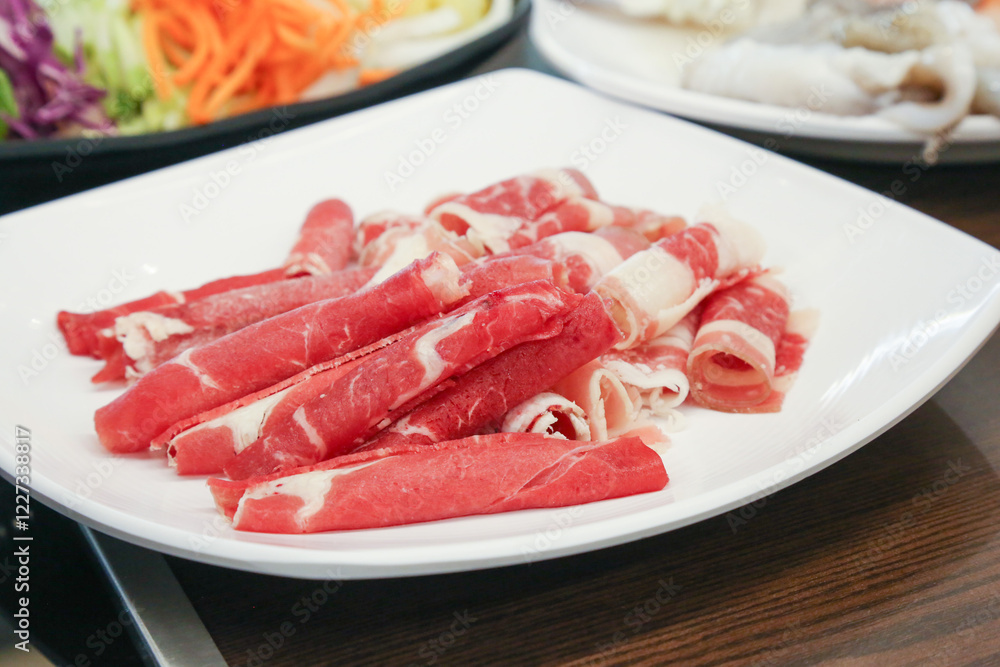 Shabu Shabu. Thinly sliced ​​beef on a plate