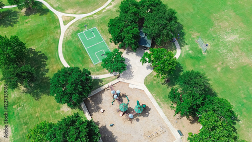 Baseball softball field with backstop netting, basketball courts, children playground equipment structure in upscale residential area West of Plano, Texas, swing, slide, woodchips ground, aerial