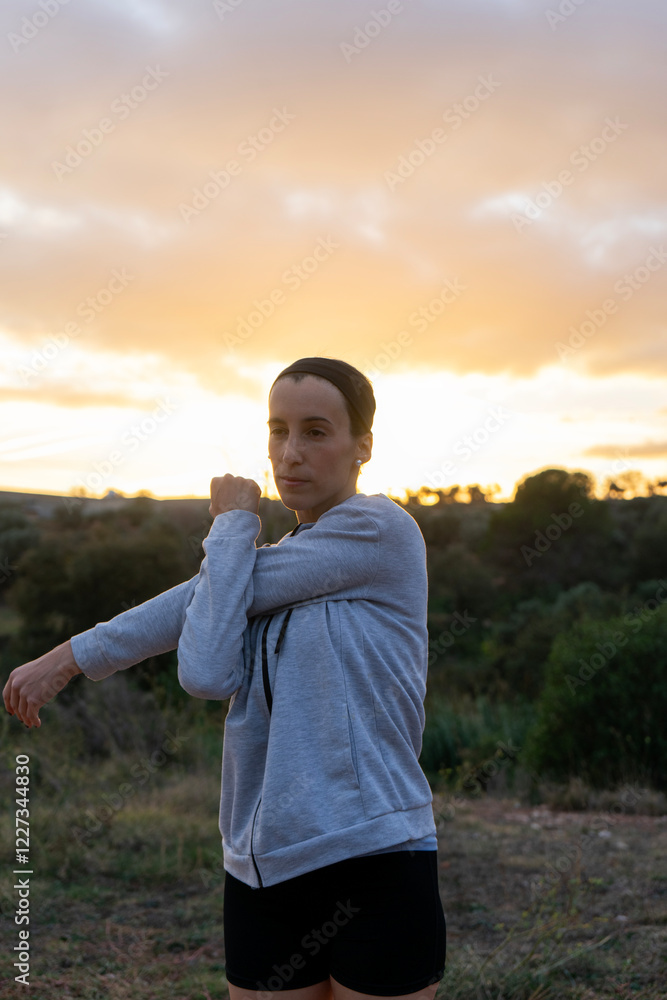 Girl doing stretching after running in the mountains at sunset. Copy space. Girl doing stretching after running in the mountains at sunset. Copy space.