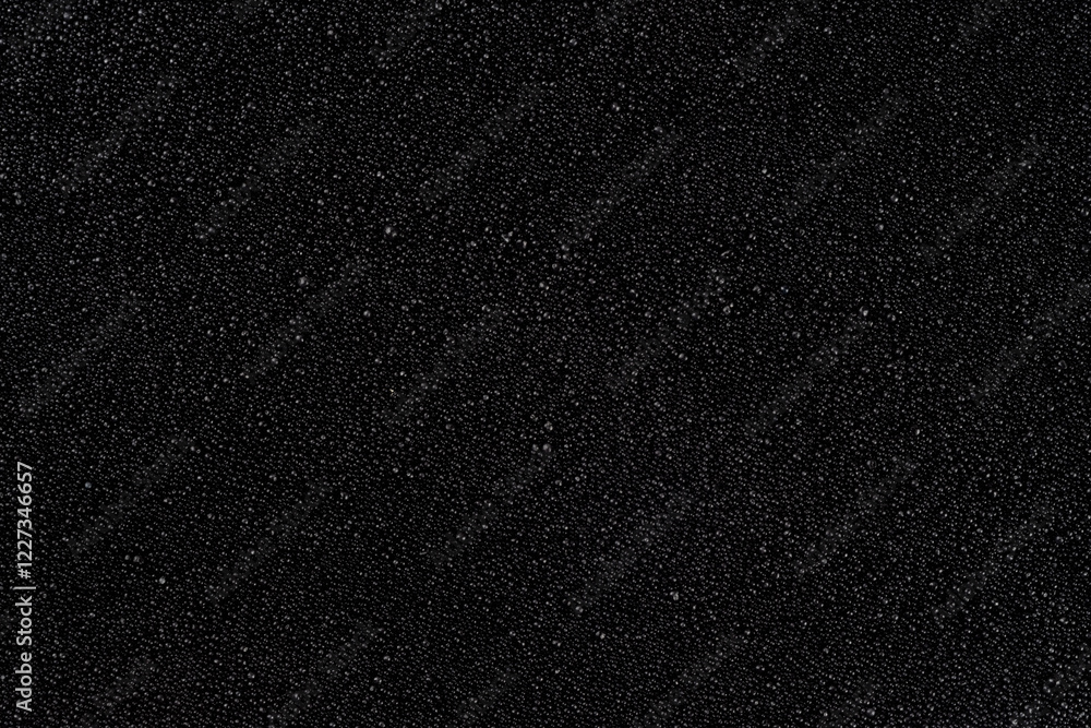 Textured background, small black pebbles or coarse sand, candle wax Textured background, small black pebbles or coarse sand, candle wax