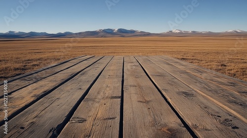 Simple wooden board in an open field, with clear skies and natural light, providing plenty of space for branding.