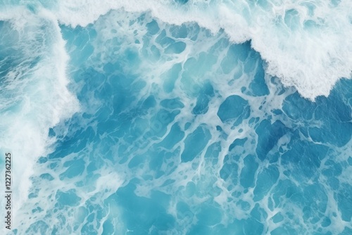 Aerial view of turquoise ocean water with white foam creating stunning patterns, perfect for backgrounds and designs related to nature, travel, and relaxation photo