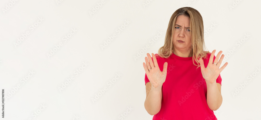 Portrait of young woman making stop sign in front of the camera. Portrait of young woman making stop sign in front of the camera.