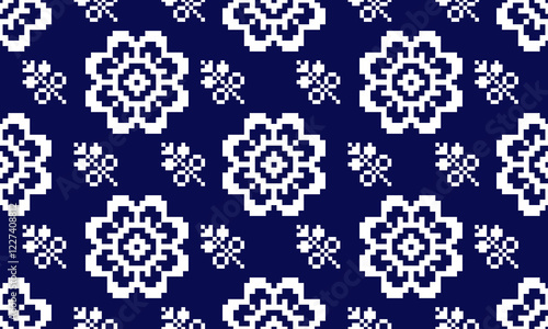 a detailed pattern composed of pixel designs with white flowers square on dark blue background , design for fabric or various pattern printing works.