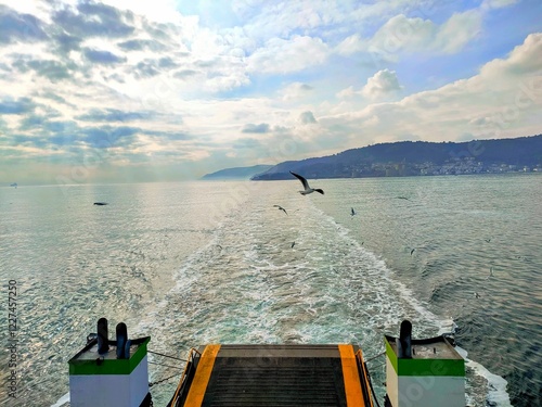 View of the sea, Dardanelles Strait, Gallipoli shores and flying seagulls from a ferry on a cloudy day. photo