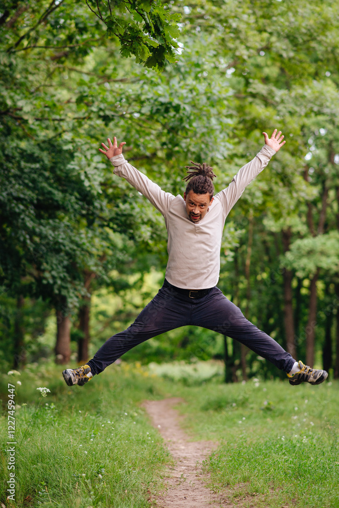 A charismatic man jumping for joy, expressing happiness and excitement. Perfect for topics on celebration, joy, and positive emotions A charismatic man jumping for joy, expressing happiness and excitement. Perfect for topics on celebration, joy, and positive emotions