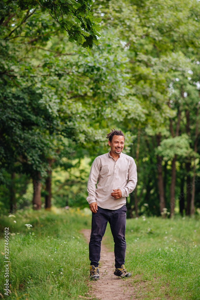 A handsome man posing in a park, ideal for portraits, lifestyle, or outdoor themes related to leisure, relaxation, and confidence A handsome man posing in a park, ideal for portraits, lifestyle, or outdoor themes related to leisure, relaxation, and confidence