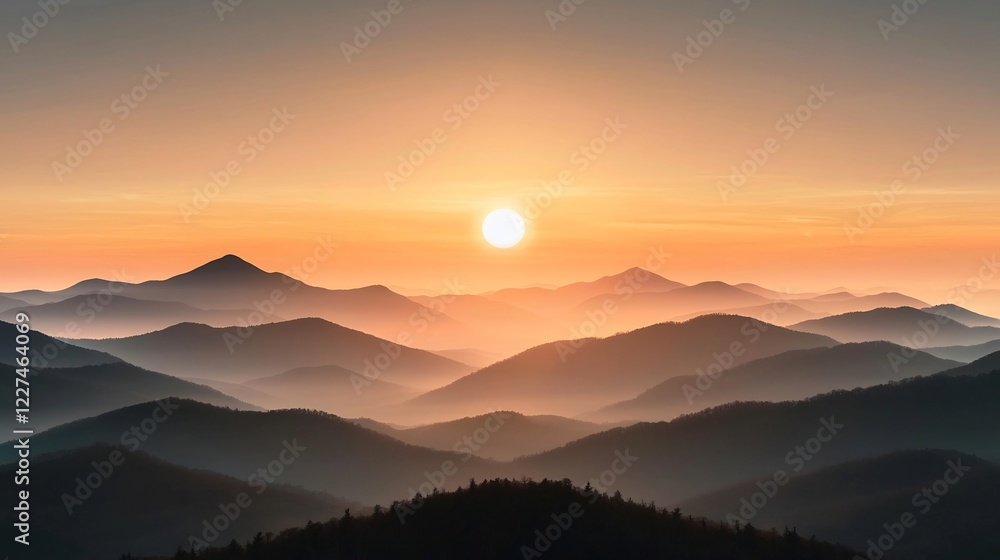 Obraz premium Serene sunrise over layered mountain ranges with soft mist and warm hues in the sky