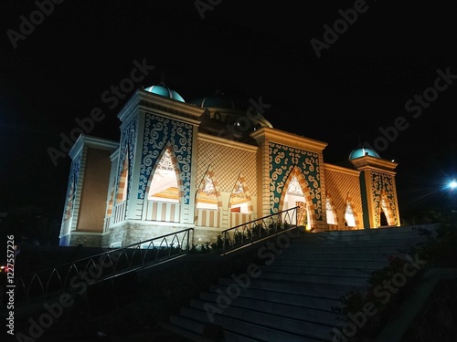 Front view mosque building under lamp light at night photo