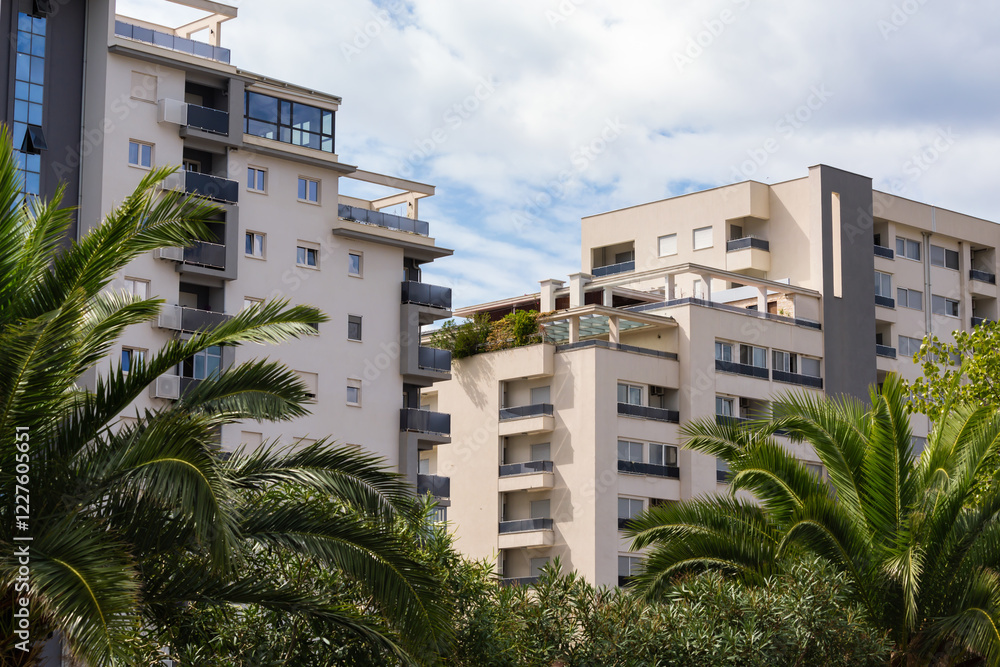 Obraz premium Modern apartment complex with balconies and palm trees in Bar, Montenegro
