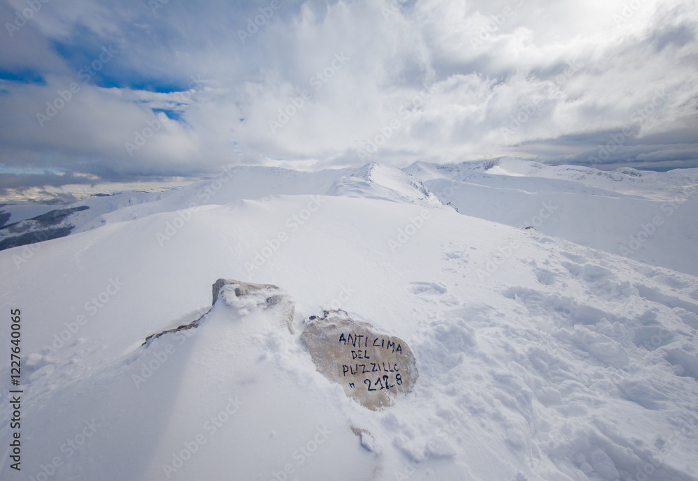Campo Felice, Italy - The suggestive plateau peak in Abruzzo region, Monte Puzzillo and Morretano summit mount range, during the winter with snow and alpinists in altitude