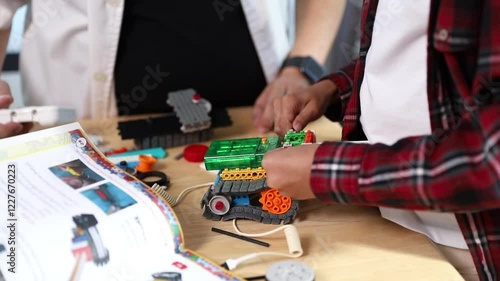 Children working on a robot design in Robotics programming class. STEM education using constructor blocks and laptop, Technology educational development for school kids