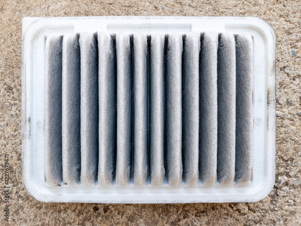 Used Car Air Filter with Heavy Dirt and Pollution Residue.