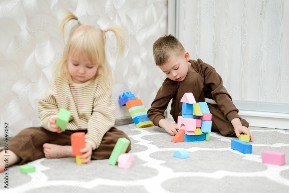 Brother and sister play with blocks and cubes at home Brother and sister play with blocks and cubes at home