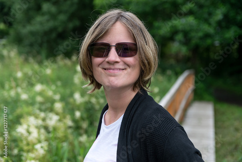 Outdoor portrait of a 31 yo white woman during a walk in nature, Ardennes, Belgium photo