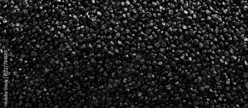 Close up view of granulated black polyamide 66 texture with ample copy space for text or graphic design applications photo