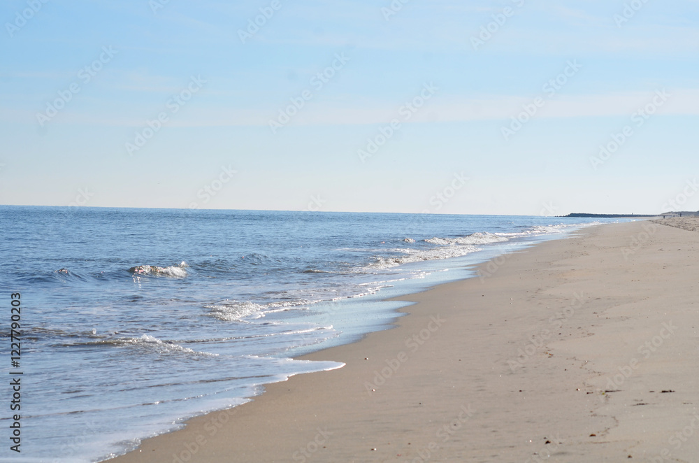 Beach at Cape Henlopen with calm waves cropped with no people Beach at Cape Henlopen with calm waves cropped with no people