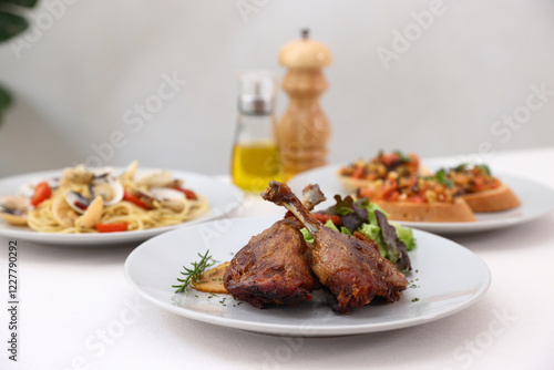 Duck leg confit with sauce. isolate in white background. top view. Duck confit on white plate