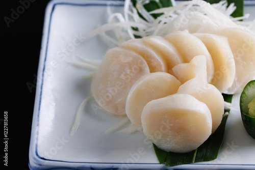 japanese scallop sashimi isolated in black background