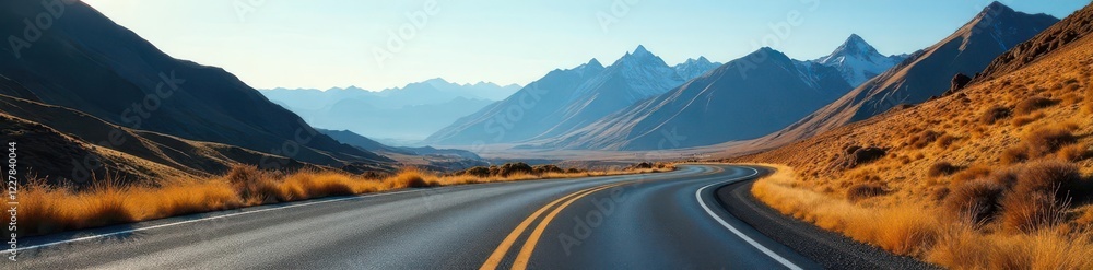 Naklejka premium Empty asphalt road curves through majestic mountains , valley, serene, hills