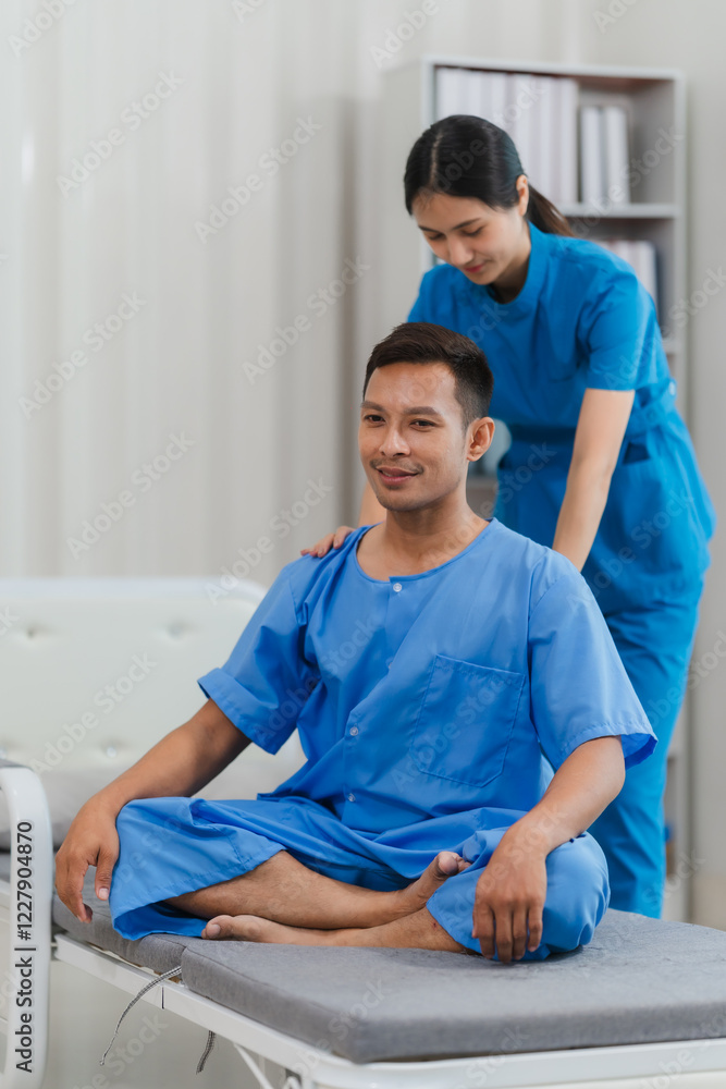 Fototapeta premium Gentle Physiotherapy: A male patient sits comfortably on an examination table, receiving attentive care from a physiotherapist during a physical therapy session. The atmosphere is calm and supportive.