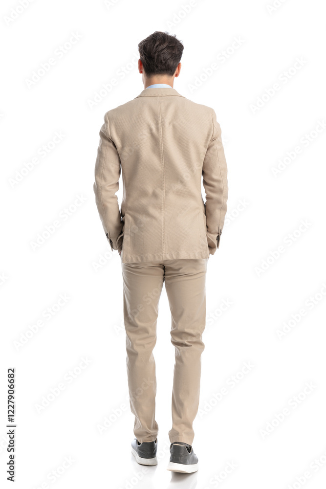 back view of relaxed smart casual man holding pockets back view of relaxed smart casual man holding pockets