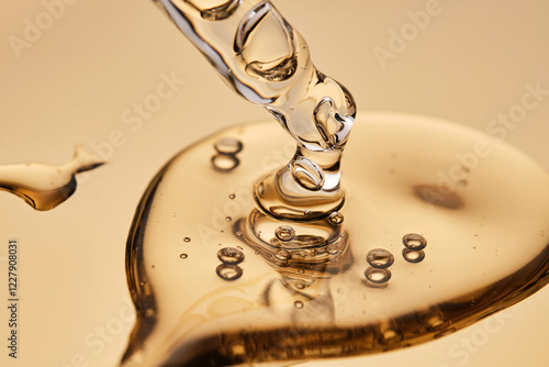 A pipette with a beautiful drop of gel-textured facial serum.