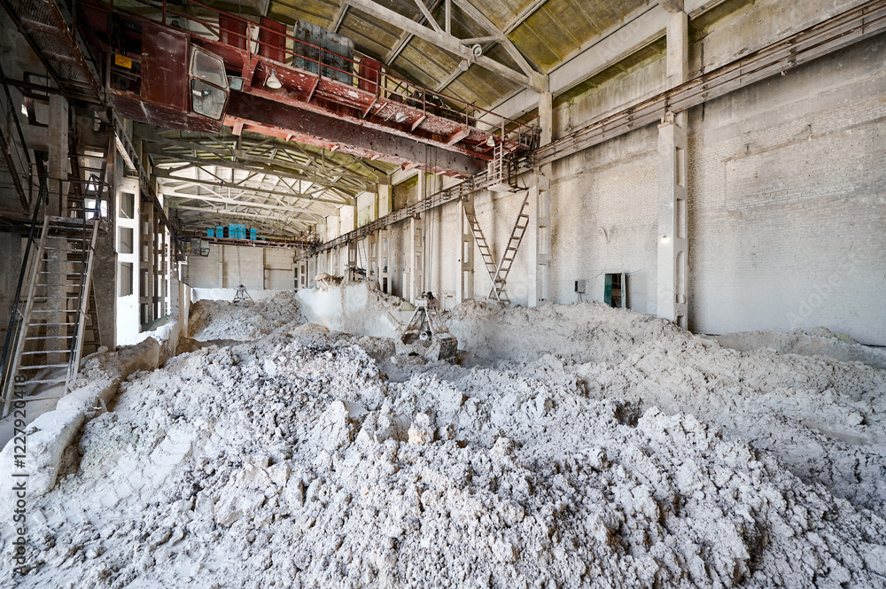 Grabber bucket operates at warehouse in pile of chalk Grabber bucket operates at warehouse in pile of chalk
