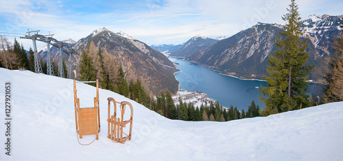 two wooden sledges at the mountain station Zwolferkopf, tobogganing in Pertisau, Tyrol with a view of Lake Achensee photo