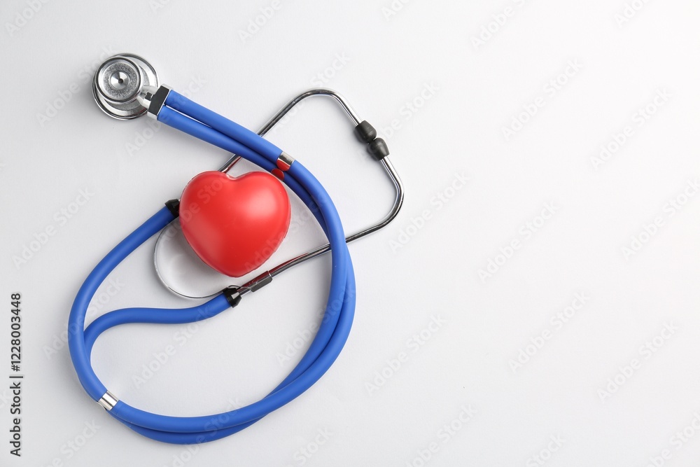 Cardiology. Stethoscope and red decorative heart on white background, flat lay. Space for text Cardiology. Stethoscope and red decorative heart on white background, flat lay. Space for text