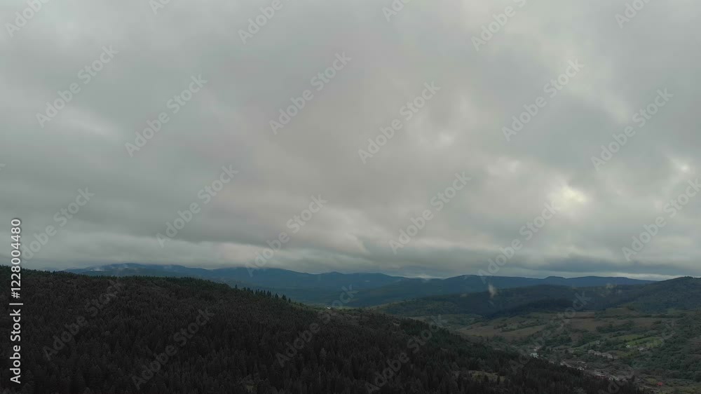 Magnificent Aerial View Of Mountains And Dense Forests Under Dark Clouds, With Raindrops Falling, Creating A Dramatic And Serene Atmosphere In A Remote Natural Landscape. Magnificent Aerial View Of Mountains And Dense Forests Under Dark Clouds, With Raindrops Falling, Creating A Dramatic And Serene Atmosphere In A Remote Natural Landscape.