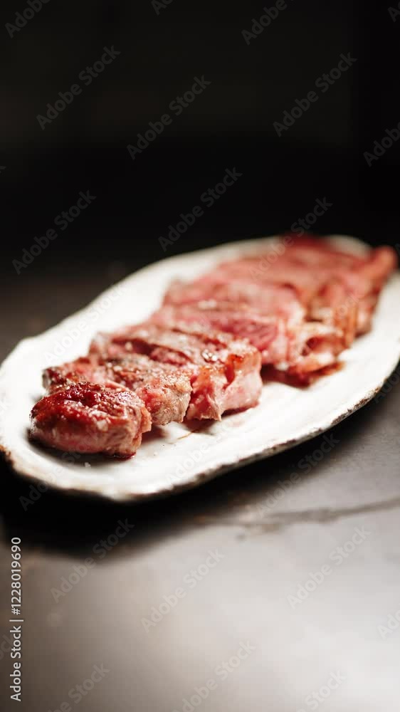 Grilled steak served on a white platter with perfect sear and juicy texture Grilled steak served on a white platter with perfect sear and juicy texture