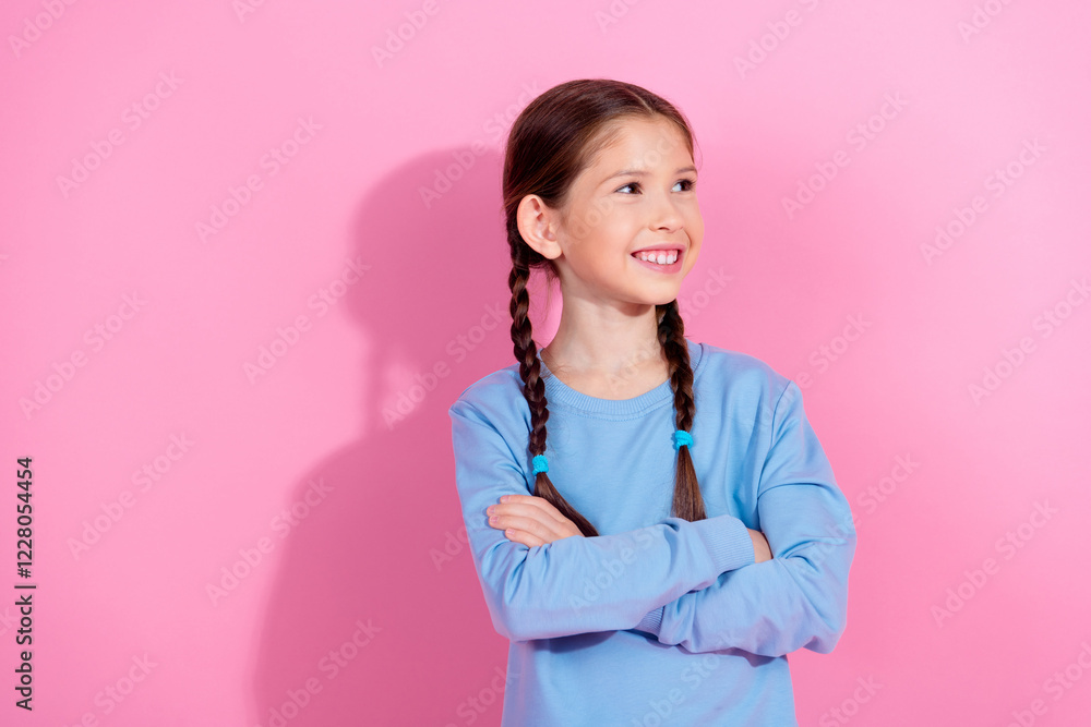 Smiling girl in blue sweatshirt posing against a bright pink background Smiling girl in blue sweatshirt posing against a bright pink background
