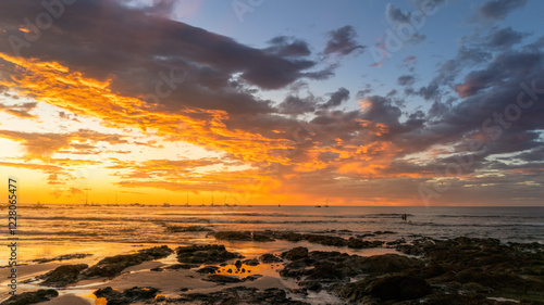 Tropical Beach Sunset with boats and dramatic cloudscape photo