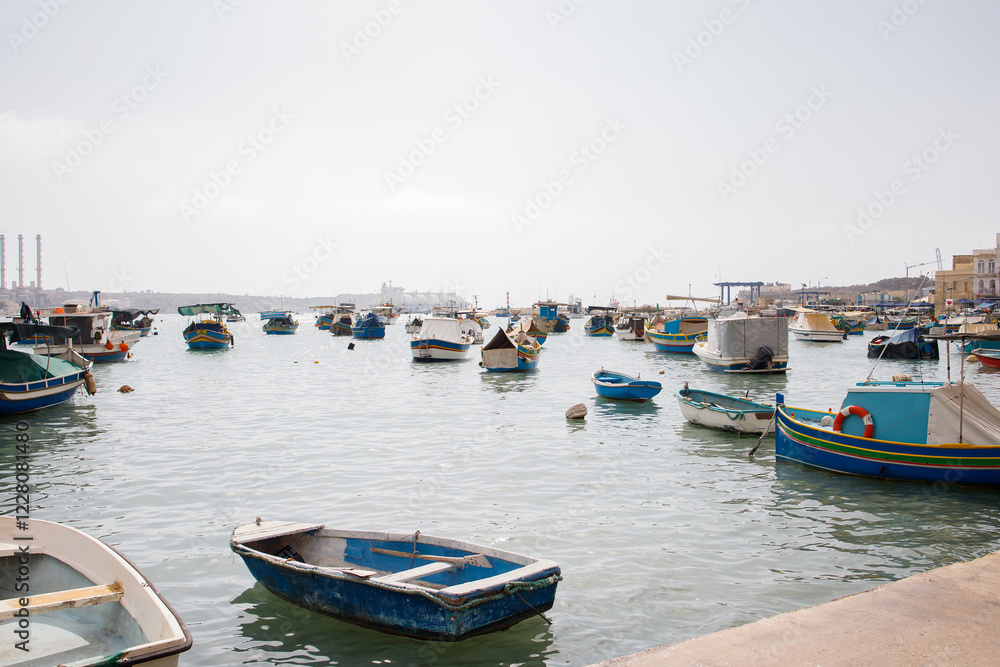 Many fishers boats moored in Marsaxlokk bay on Malta Many fishers boats moored in Marsaxlokk bay on Malta