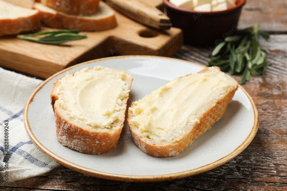Fresh bread with butter on wooden table, closeup Fresh bread with butter on wooden table, closeup