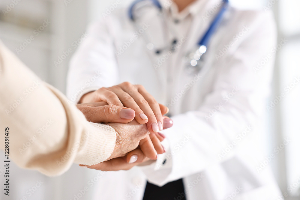 Doctor supporting patient during appointment in hospital, closeup of hands Doctor supporting patient during appointment in hospital, closeup of hands