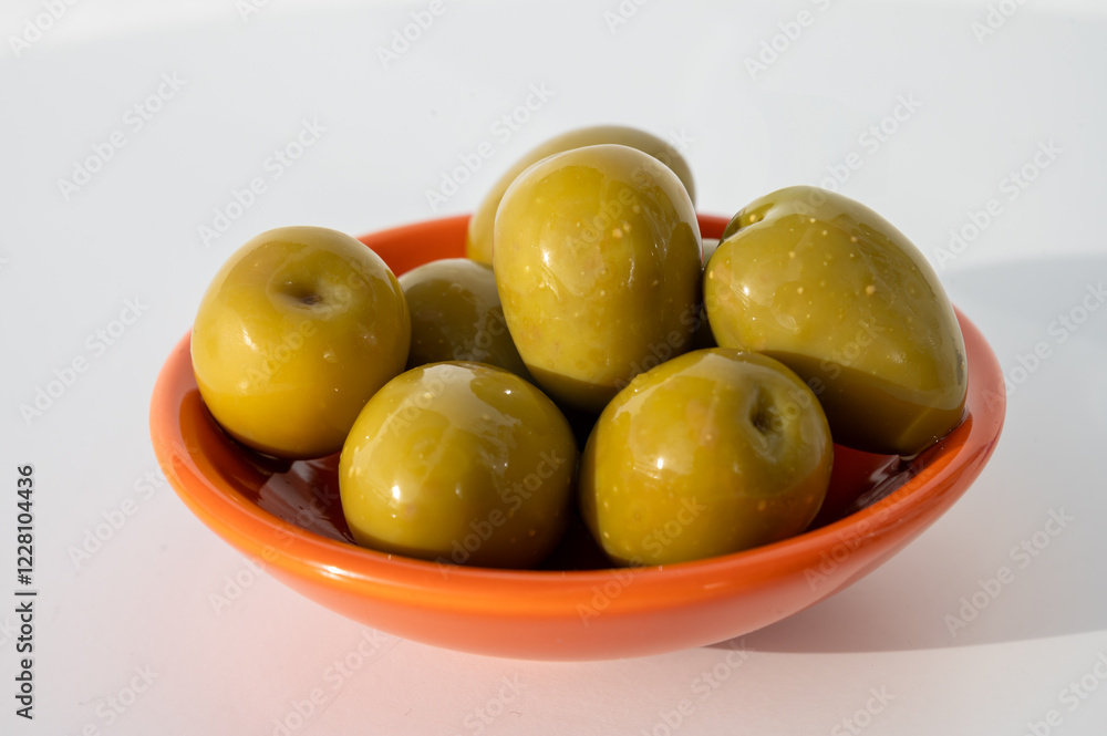 Homemade pickled big green olives in bowl, spanish tapas close up Homemade pickled big green olives in bowl, spanish tapas close up