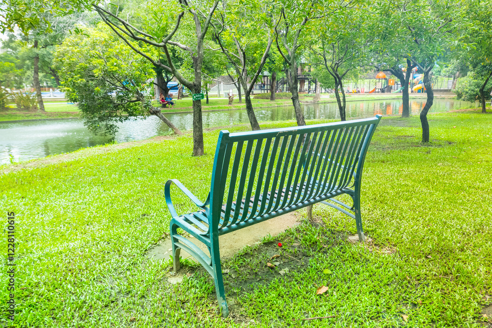 Modern bench in a public Park with view of fountain in the water pond public park,lake during spring,Beautiful green garden and Big tree,reflection in the lake in the morning,Resting in Park.. Modern bench in a public Park with view of fountain in the water pond public park,lake during spring,Beautiful green garden and Big tree,reflection in the lake in the morning,Resting in Park..
