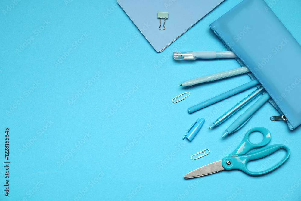 Pencil case and different stationery on light blue background, flat lay. Space for text Pencil case and different stationery on light blue background, flat lay. Space for text