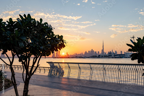 beautiful sunset view of Dubai Downtown cityline and Dubai Creek canal photo