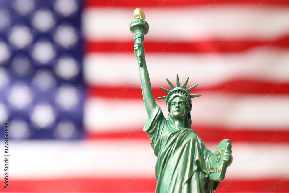 Fototapeta premium Statue of Liberty against flag of USA, closeup. Space for text