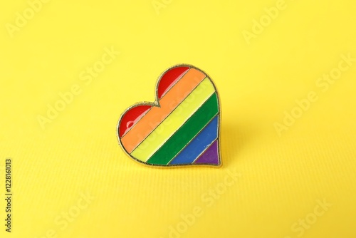 Heart shaped badge in LGBT colors on yellow background photo