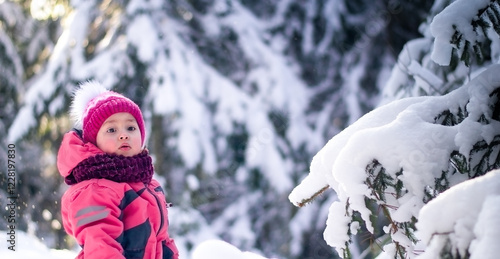 Snow-covered branches of fir trees and a child