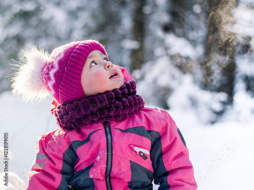 Girl looking up at the flying snow