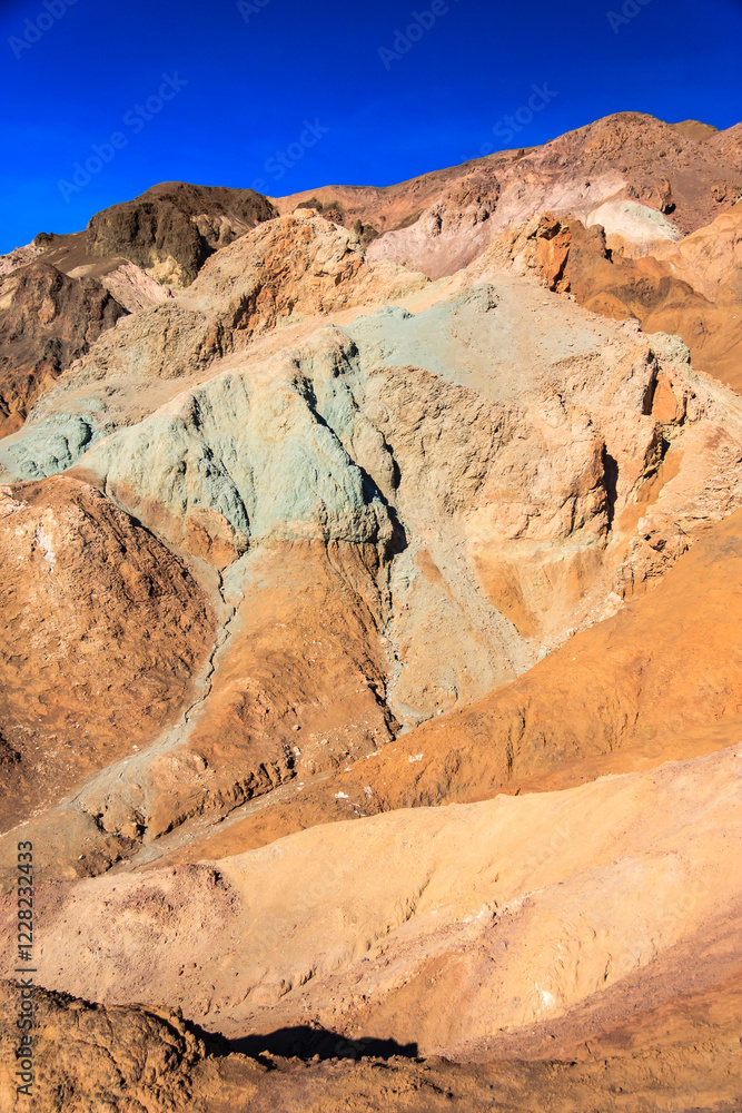 Fototapeta premium A mountain range with a blue and green rock formation